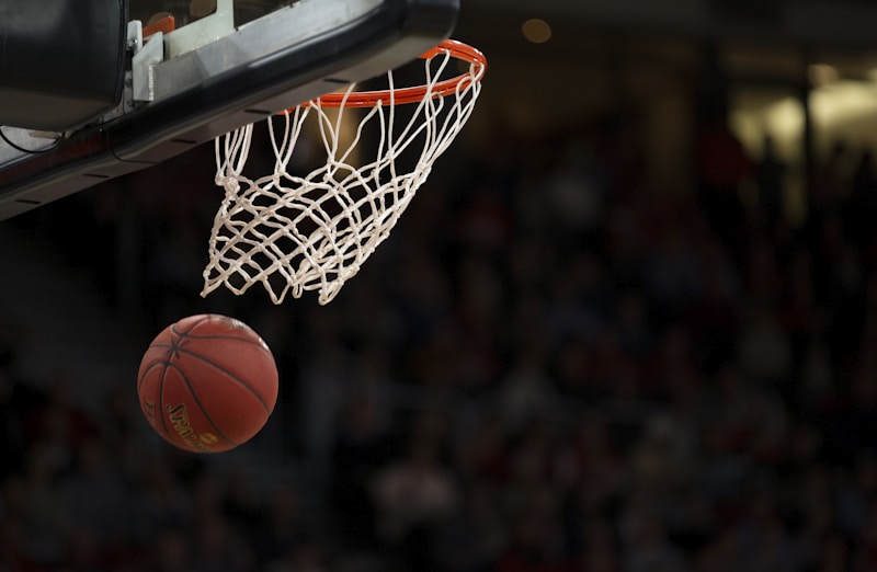 NBA篮球赛场精彩扣篮瞬间，球员腾空而起展现出色弹跳力与爆发力
